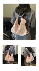Detailed view of pink faux leather hobo bag with silver M rivet and mini round pouch