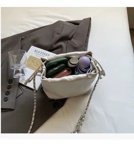 Top view of white drawstring bucket bag showing large capacity with personal items inside