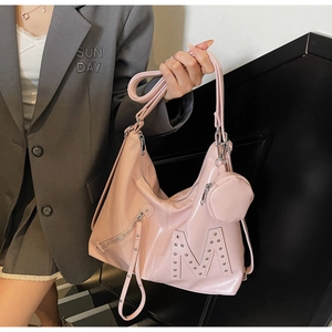 Close-up of pink glossy tote bag with metal rivet M logo and matching mini round pouch