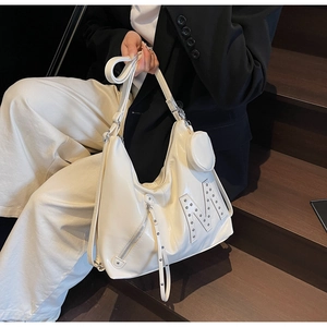 Detail of white glossy leather tote bag with metal rivet M logo and mini round coin purse