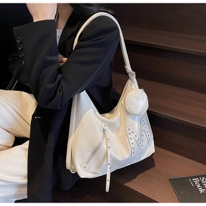Detail of off-white hobo bag showing silver rivet M logo and round mini coin purse