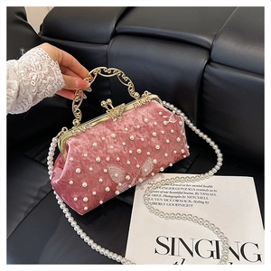 Nahaufnahme der rosa Samt-Abendtasche mit Perlen-Schmetterlingsstickerei und Goldgriff