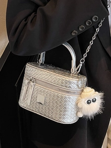 Silver woven texture box handbag with chain strap and cute plush charm on black coat