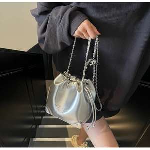Close-up of silver drawstring bucket bag with MIAOSHE text and metal chain strap
