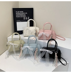 Detailed view of colorful mini pillow bags with lace bows and striped pendants