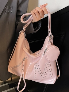 Pink Y2K hobo bag in glossy faux leather featuring rivet M detail and small coin purse