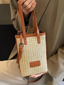 Rainbow straw woven crossbody bag with brown leather handles and adjustable strap for summer