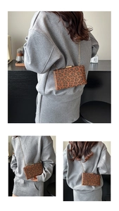 Dettaglio della pochette leopardata con chiusura in metallo dorato e sottile catena