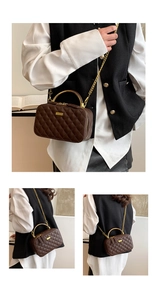 Close-up of diamond-quilted brown PU leather bag with golden metal handle and chain
