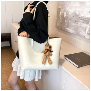 Borsa tote bianca con goffratura coccodrillo e ciondolo a forma di orso sulla spalla