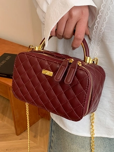 Classic burgundy quilted leather box bag with gold metal handle and chain strap