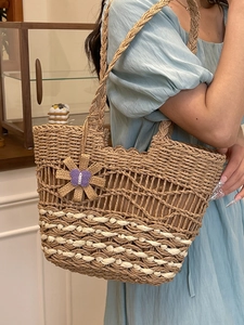 Handmade woven straw tote bag with floral pendant for summer beach vacation style