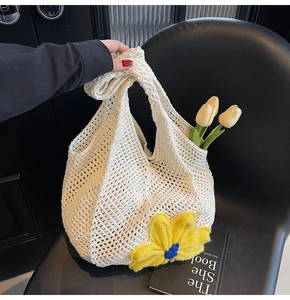 Detailed view of cream crochet tote bag with 3D yellow flower and hollow woven mesh