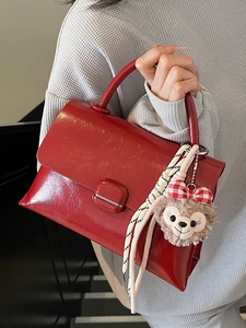 Sac à main chic en cuir verni rouge brillant avec rabat élégant et boucle décorative