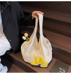 Close-up of hand-woven beige hollow tote bag with yellow 3D crochet flower detail