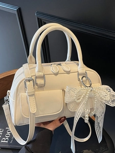 Elegant cream white Boston handbag with lace pearl bow charm and adjustable strap