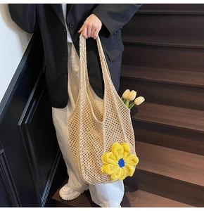 Detail view of beige hand-woven crochet tote bag featuring vibrant yellow 3D floral accents