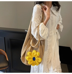 Close-up of woven mesh tote bag with a large 3D yellow knit sunflower detail