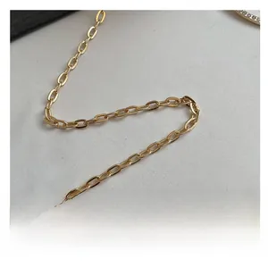 Close-up of the polished gold metal chain strap with long oval links for handbags