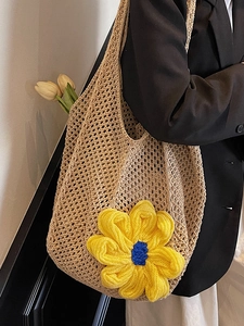 Minimalist beige woven tote bag with large floral accent for summer vacation style