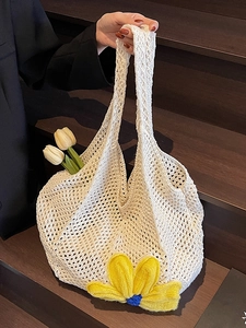 Chic woven tote bag in off-white with large yellow crochet flower for summer