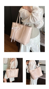 Close-up of pink embossed leather tote bag with lace bow and pearl pendant detail