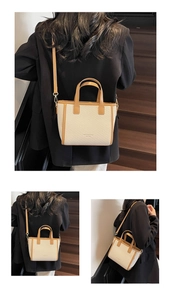 Detail view of woven beige tote bag with brown leather trim and adjustable strap
