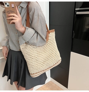 Detailed view of handmade woven tote bag with brown leather straps and mesh pattern