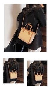 Detail of a chic beige woven tote bag with brown leather trim and slim shoulder strap