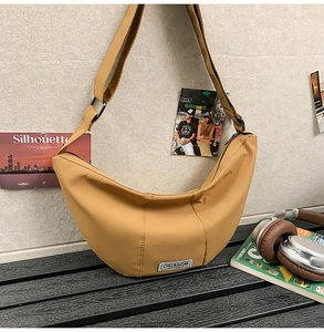 Détail du sac croissant en nylon jaune moutarde avec bandoulière réglable en ville