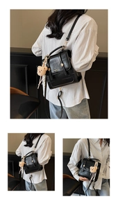 Detail view of black PU leather backpack with gold buckle and teddy bear charm