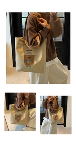 Detail of embroidered canvas tote bag featuring a brown pocket and colorful weekday letters