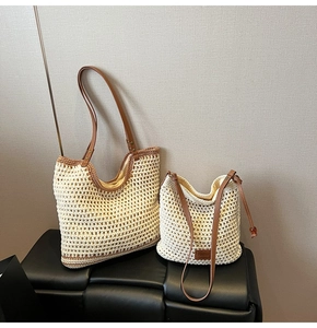 Detail of woven straw tote bags in creamy white with premium brown leather straps
