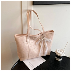 Detail of light pink tote bag with cartoon animal embossing and pearl lace bow charm