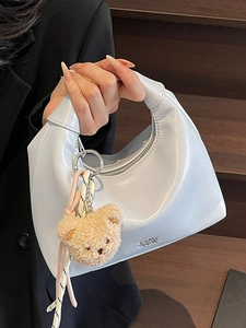 Minimalist light blue patent leather hobo bag with teddy bear charm and silver logo