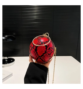 Detailed view of spherical snake pattern evening bag with rhinestone ring handle and chain