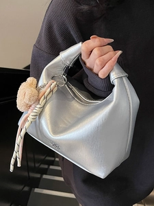 Sleek metallic silver crescent hobo bag with teddy charm and woven rope accessory