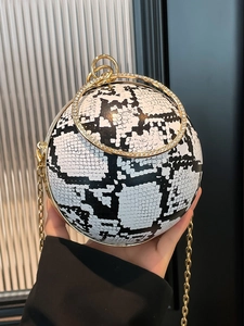 Spherical evening bag with black and white snakeskin pattern and rhinestone handle
