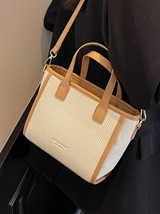 Elegant bucket bag for women with cream fabric texture and brown leather trim details