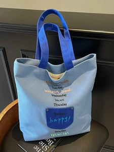 Casual blue canvas tote bag with colorful embroidery days of the week on black background