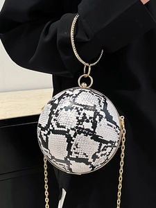 Spherical evening bag with black and white snakeskin print and diamond-set ring handle