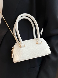 Minimalist white shell-shaped tote bag in grainy texture with a gold bead chain strap