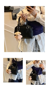 Detail view of black faux leather bowling bag with silver zipper and cute bear charm