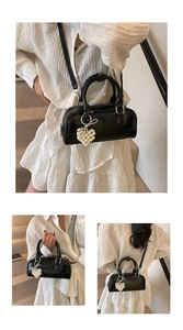 Three views of a black bowling bag with pearl heart charm and adjustable shoulder strap