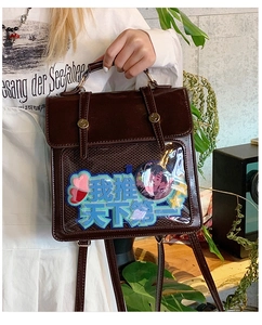 Detail view of brown PU leather Ita-bag featuring a transparent window and gold buckles