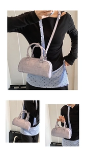 Detail of lavender glossy bowling bag featuring crinkled texture and silver hardware
