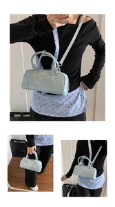 Three-way view of light blue patent leather bowling bag with silver strap detail