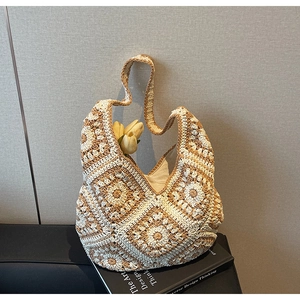 Detailed close-up of handmade crochet tote bag featuring sunflower patterns and cotton texture