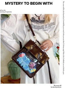 Detail of dark brown retro PU ita bag with transparent window and adjustable strap