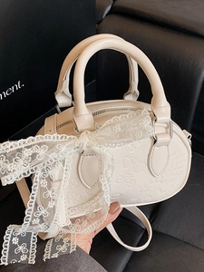 Creamy white Boston bag with embossed patterns and large white lace bow decoration